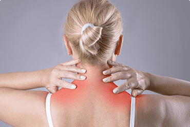 A woman with her hands on the back of her neck.