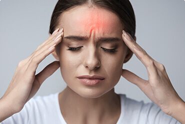 A woman with her hands on the head.